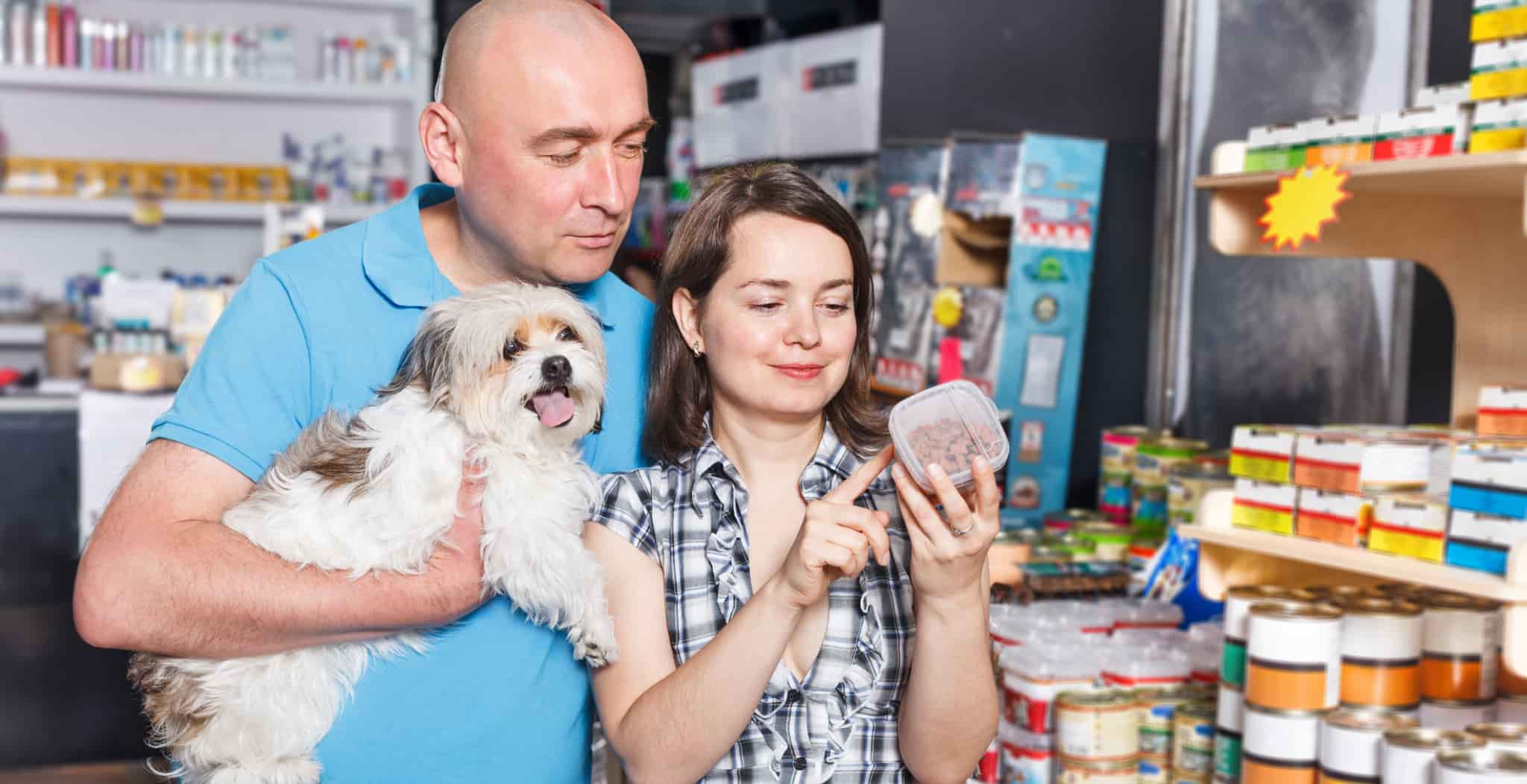 Which Natural Foods Are Best for Your Dog's Overall Health & Well-Being? man and women buying dog food.